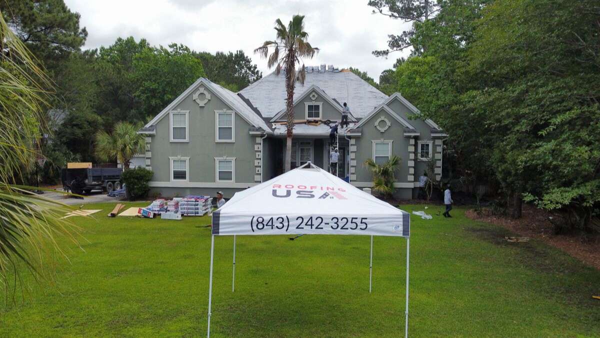 A Roofing USA tent in front of a roofing project, residential roof replacement Charleston, SC, concept