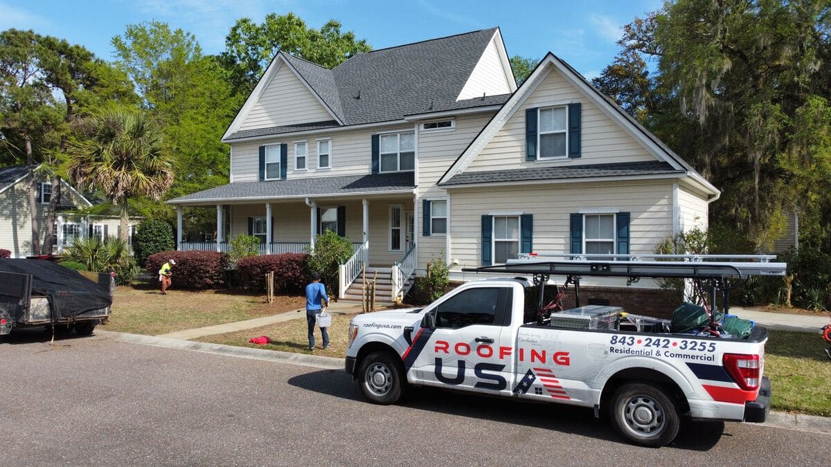 A Roofing USA truck in front of a home