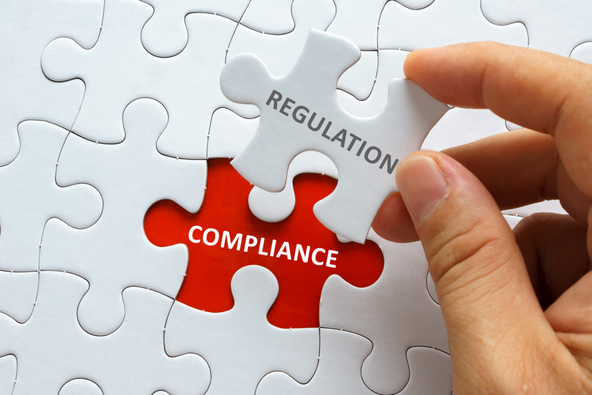 A puzzle piece labeled regulation fitting in a space labeled compliance