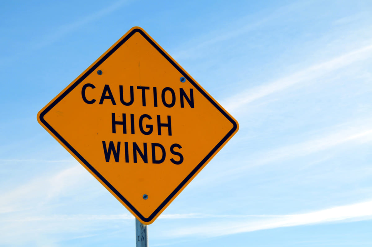 A warning sign that says caution high winds