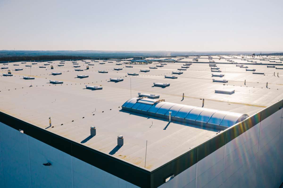 Large commercial roof of a factory with roof ventilators