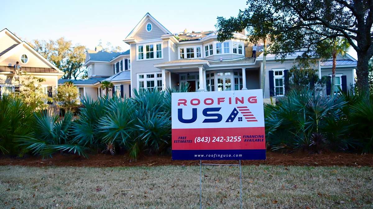 Roofing USA sign in front of a home with a new roof, best roofers in Charleston concept