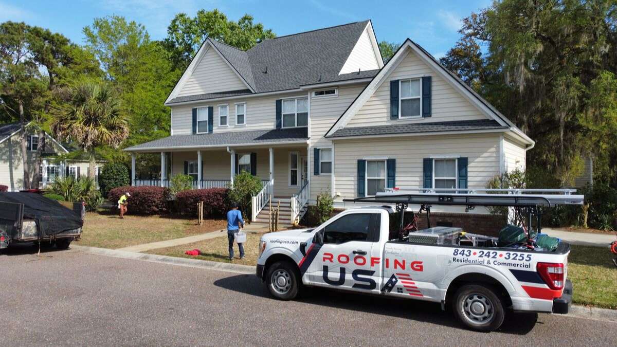Roofing USA truck in front of a new roof from one of the best roofing companies Charleston, SC, offers