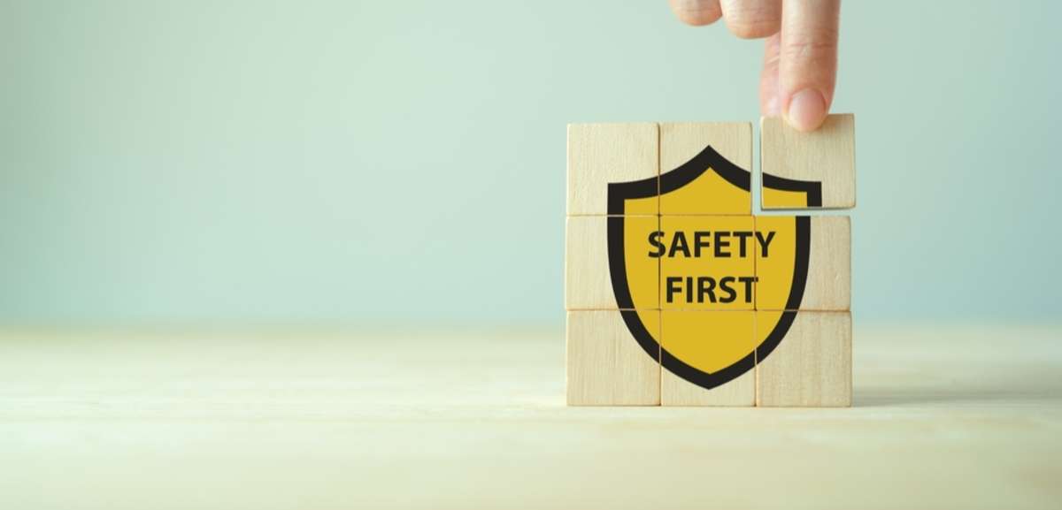 Wooden blocks with a safety symbol on them, showing the words safety first