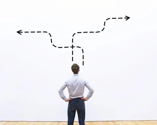 A_man_looking_at_two_arrows_going_in_different_directions (1)