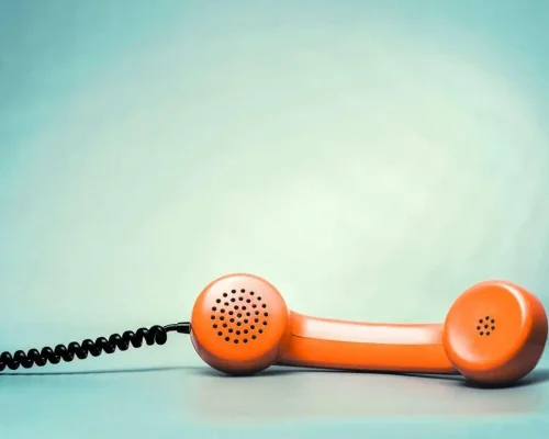 An_orange_phone_handset_represents_calling_the_best_local_roofers_Charleston,_SC,_offers
