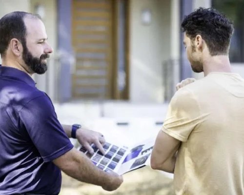 An_outside_sales_rep_from_Roofing_USA_shows_a_homeowner_the_best_options_for_roofing_services (1)