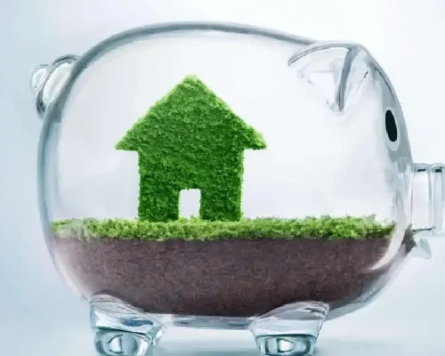 Saving_to_buy_a_house_or_home_savings_concept_with_grass_growing_in_shape_of_house_inside_transparent_piggy_bank (1)