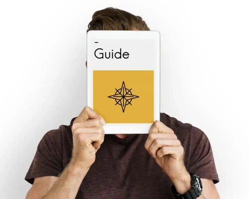 Someone_holding_a_book_that_says_guide,_a_guide_to_commercial_roofing_materials_concept