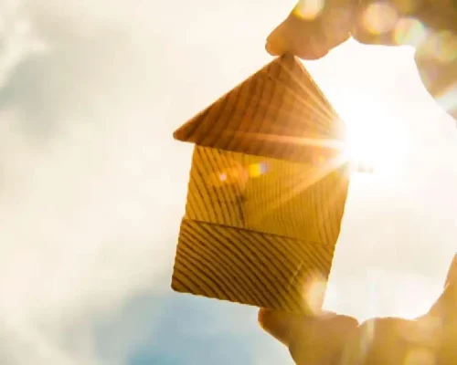 Sun_shining_behind_a_small,_wooden_building,_the_effects_of_heat_on_your_roof_concept